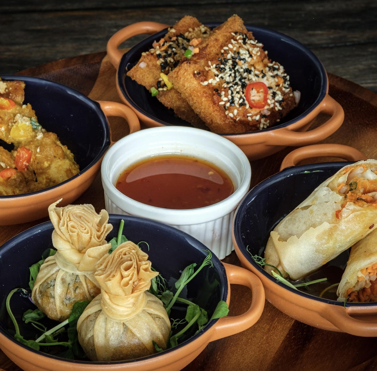 The front view of the White Hart Inn in Ironbridge Telford. There is outdoor seating in the courtyard with large umbrellas and outdoor heating